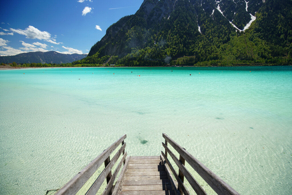 Achen lake turquoise water and Alps mountains view, Tyrol region of Austria